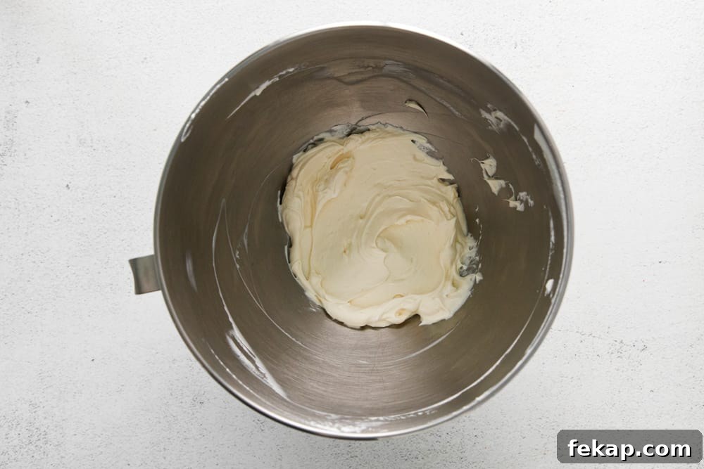 How to Make Chocolate Cheesecake Mousse Cups 12 cream cheese and vanilla extract beaten in a stainless mixing bowl.