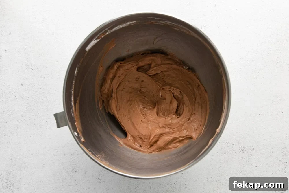 How to Make Chocolate Cheesecake Mousse Cups 14 no bake chocolate cheesecake batter in a stainless mixing bowl.