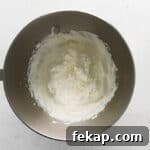 How to Make Chocolate Cheesecake Mousse Cups 5 beaten whipped cream in a stainless mixing bowl.