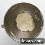 How to Make Chocolate Cheesecake Mousse Cups 6 cream cheese and vanilla extract beaten in a stainless mixing bowl.