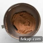 How to Make Chocolate Cheesecake Mousse Cups 8 no bake chocolate cheesecake batter in a stainless mixing bowl.