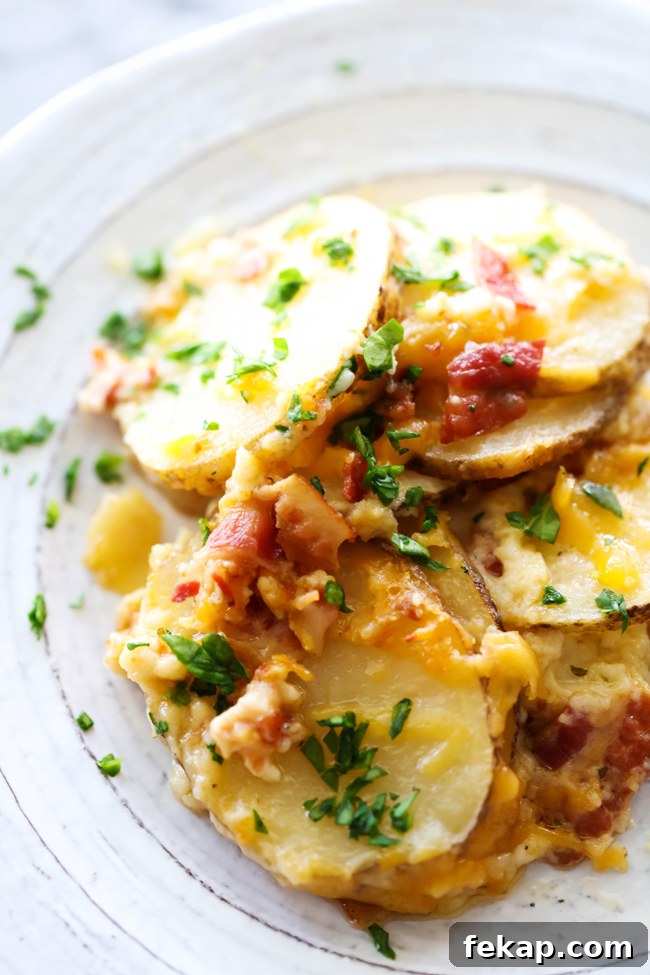 Cheesy Bacon Ranch Scalloped Potatoes Recipe 5 Sliced serving of bacon ranch scalloped potatoes on a plate