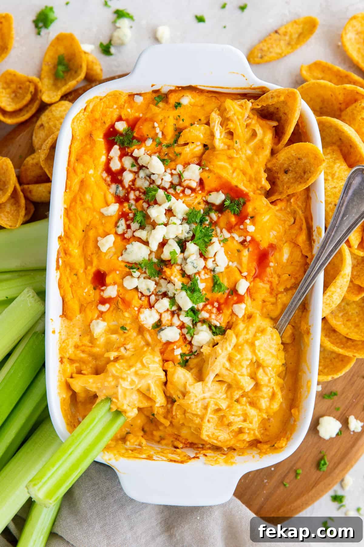 An over the top shot of Buffalo Chicken Dip with Frank's Red Hot Sauce in a white baking dish.