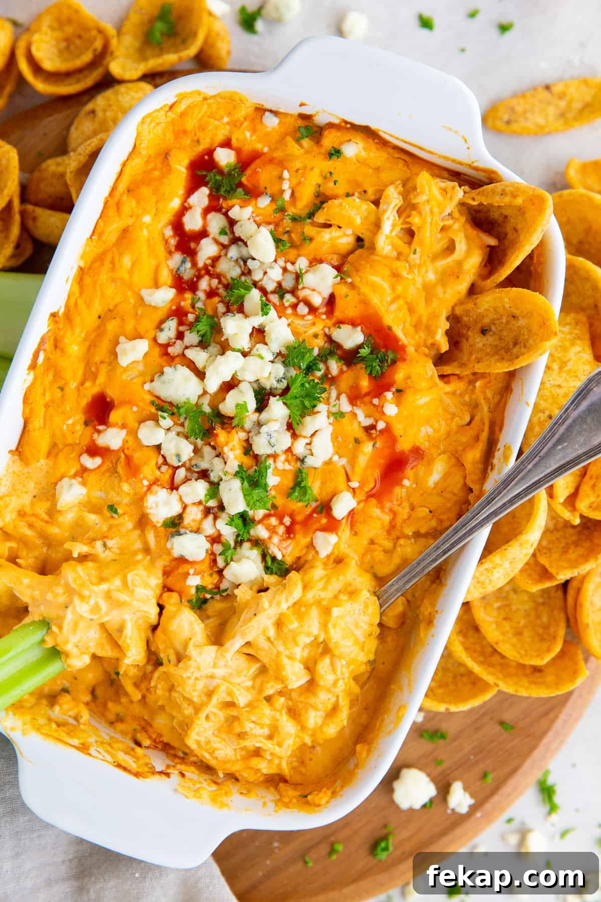 An over the top shot of Buffalo Chicken Dip topped with green onion and blue cheese.