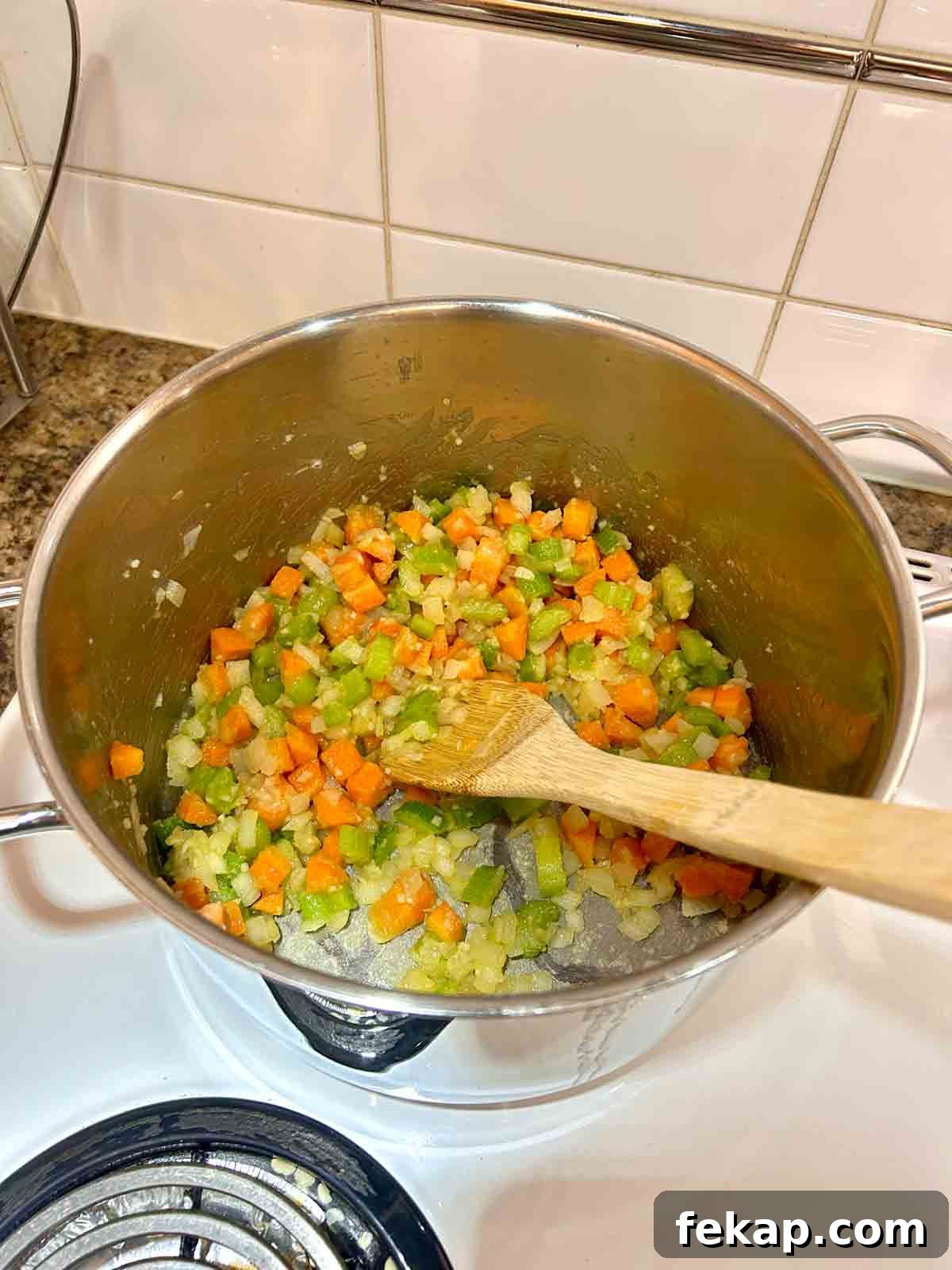 flour stirred into veggies in pot.