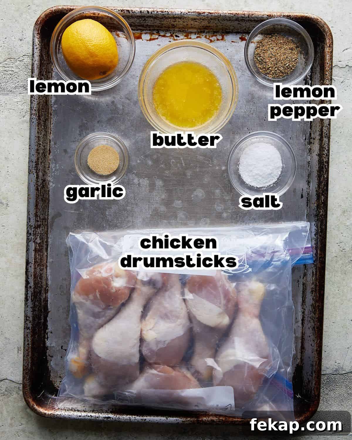 Overhead image ingredients needed to make lemon pepper chicken drumsticks.