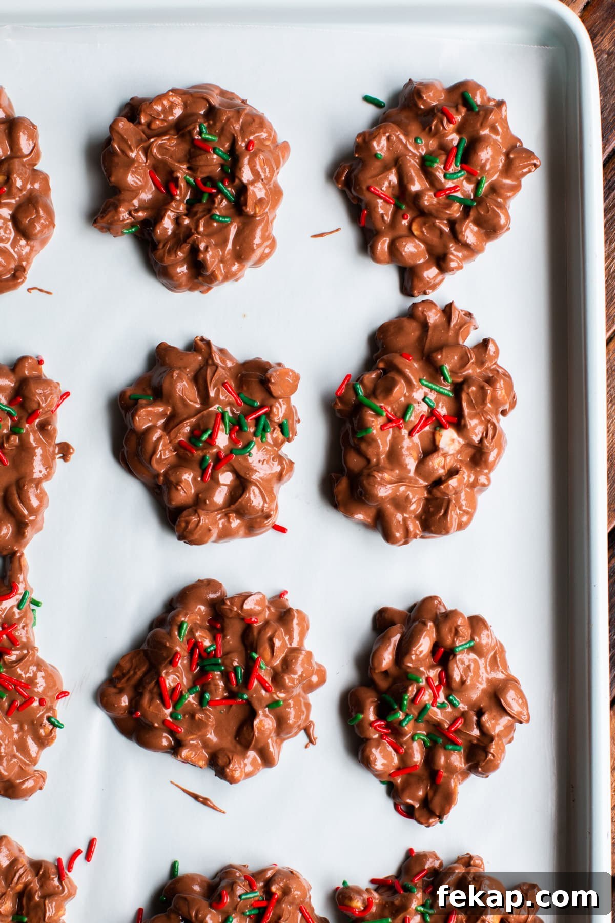 Slow Cooker Peanut Clusters Recipe 2 not yet set peanut clusters on a sheet pan