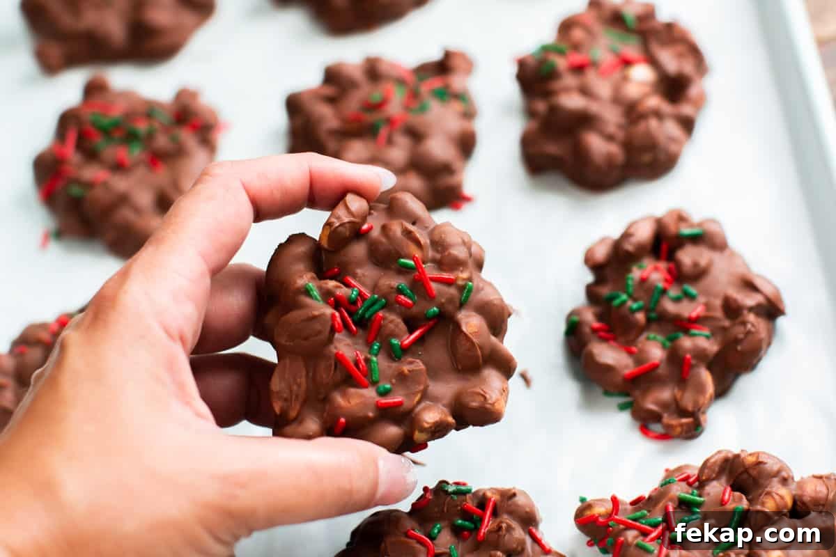 Slow Cooker Peanut Clusters Recipe 7 hand holding a peanut cluster
