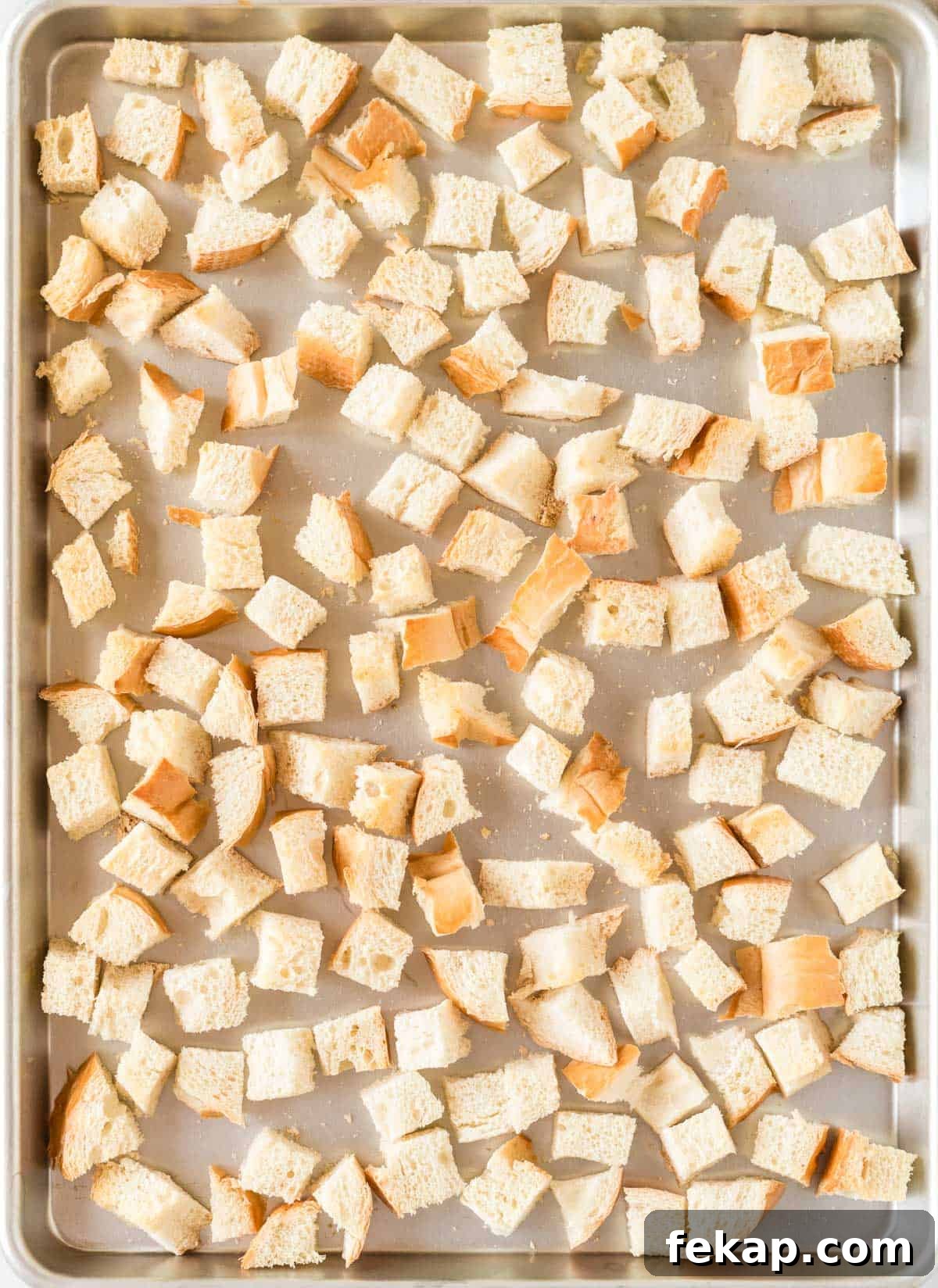 bread cubes on a baking sheet