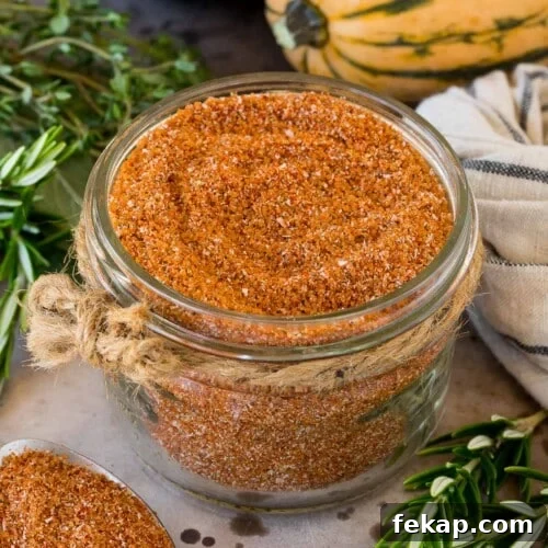 Smoked Turkey Rub Recipe for Juicy Flavorful Turkey 12 A jar of smoked turkey rub surrounded by herbs and winter squash.