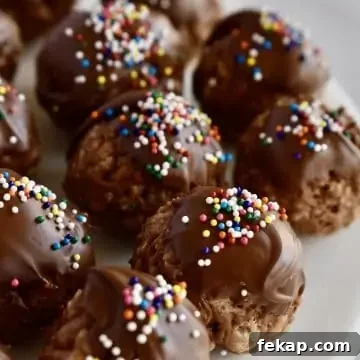Crispy Nutella Truffles with chocolate and sprinkles on top on a white plate.