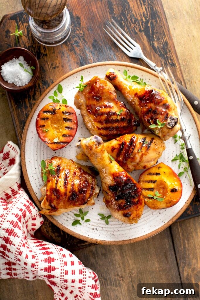 Grilled Chicken with Sticky Peach Glaze 6 Glazed chicken legs and thighs served on a plate with grilled peaches
