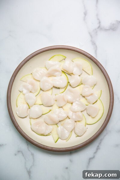 raw sliced scallops on a plate