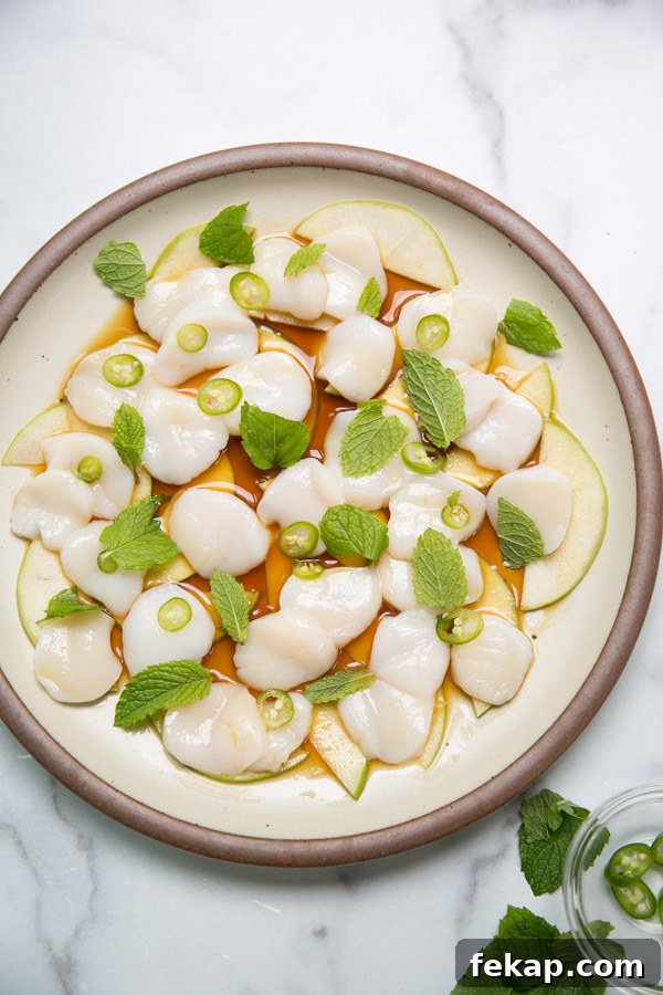 raw scallop crudo on a plate with japanese ponzu sauce