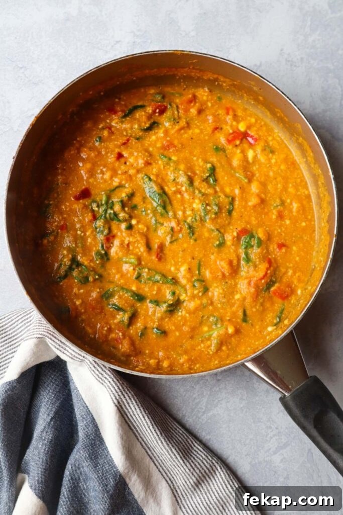 skillet with pumpkin feta sauce with spinach and red bell pepper