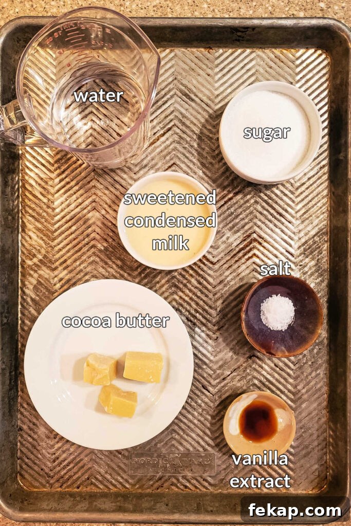 How to Make Silky White Chocolate Sauce 3 An overhead shot of all the ingredients to make white chocolate coffee syrup in small bowls on a cookie sheet.