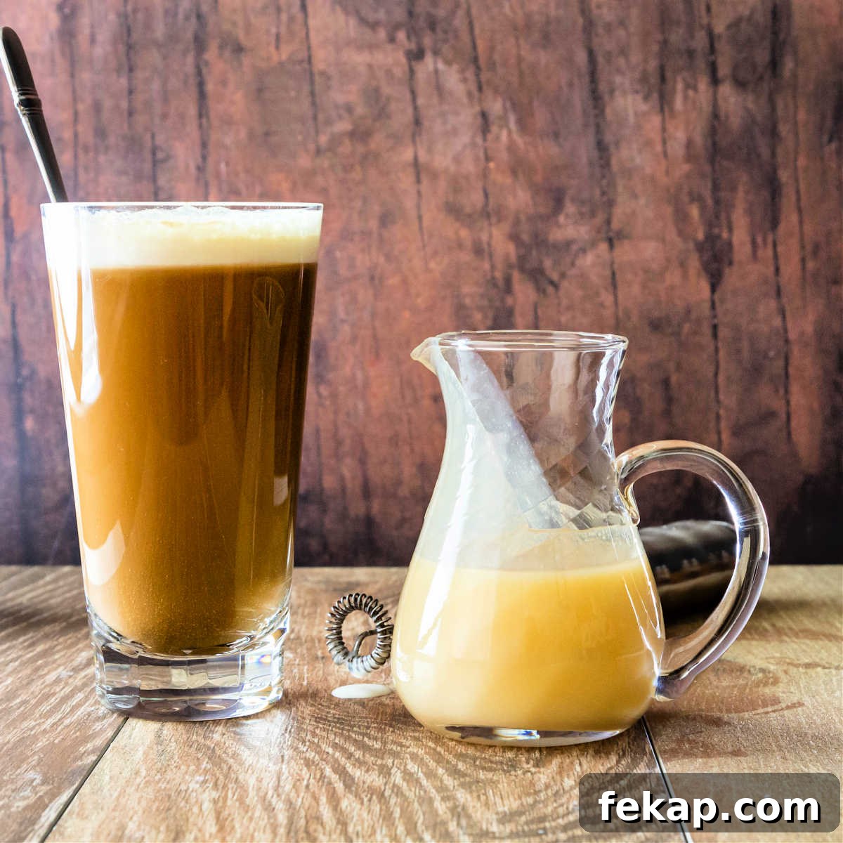 How to Make Silky White Chocolate Sauce 5 A glass with white chocolate mocha and a glass pitcher of white chocolate coffee sauce.