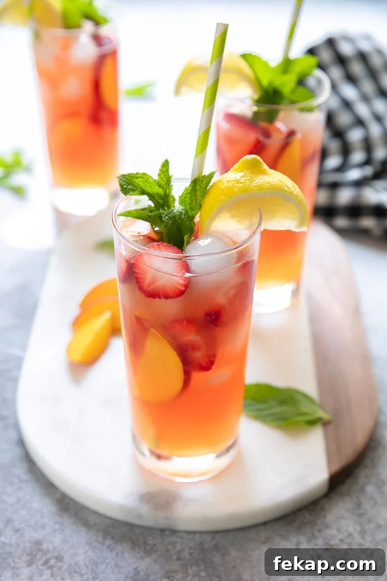 Refreshing Peach Strawberry Lemonade Recipe for Summer 4 Bright pink strawberry and peach lemonade filled with fresh peaches and strawberries