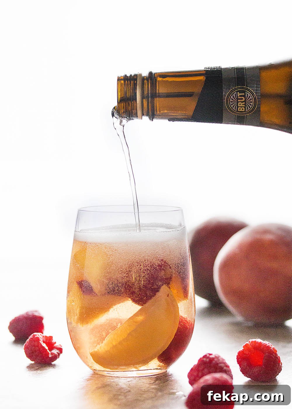 This sparkling white peach sangria is super easy to mix together and just as easy to enjoy on a warm day. Not too sweet and full of fizz from the bubbly, it's the taste of summer in a glass!