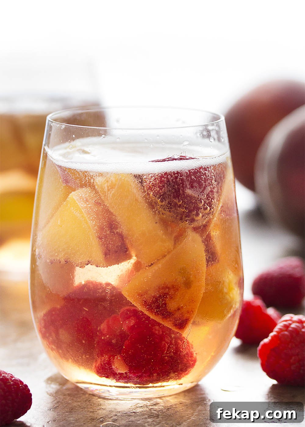 This sparkling white peach sangria is super easy to mix together and just as easy to enjoy on a warm day. Not too sweet and full of fizz from the bubbly, it's the taste of summer in a glass!
