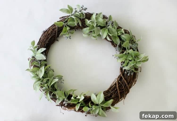 Bright pops of citrus, greenery and gingham combine for an adorable & easy citrus wreath to make this summer! wreath with greenery wired on