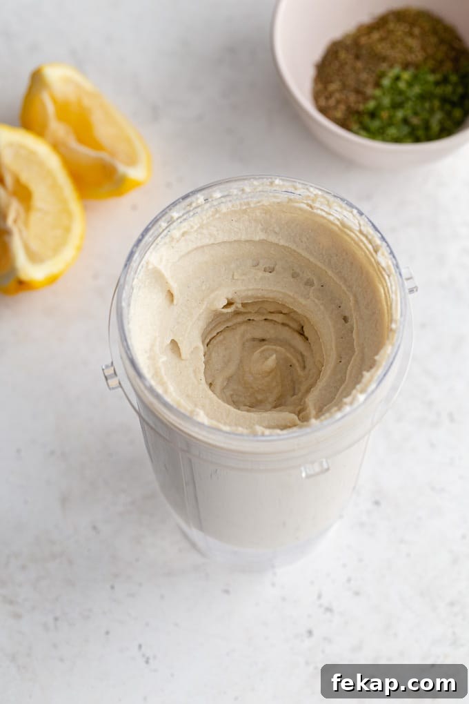 Creamy Vegan Herb Dip Recipe 5 Overhead view of the cashew mixture blended together in a blender cup.