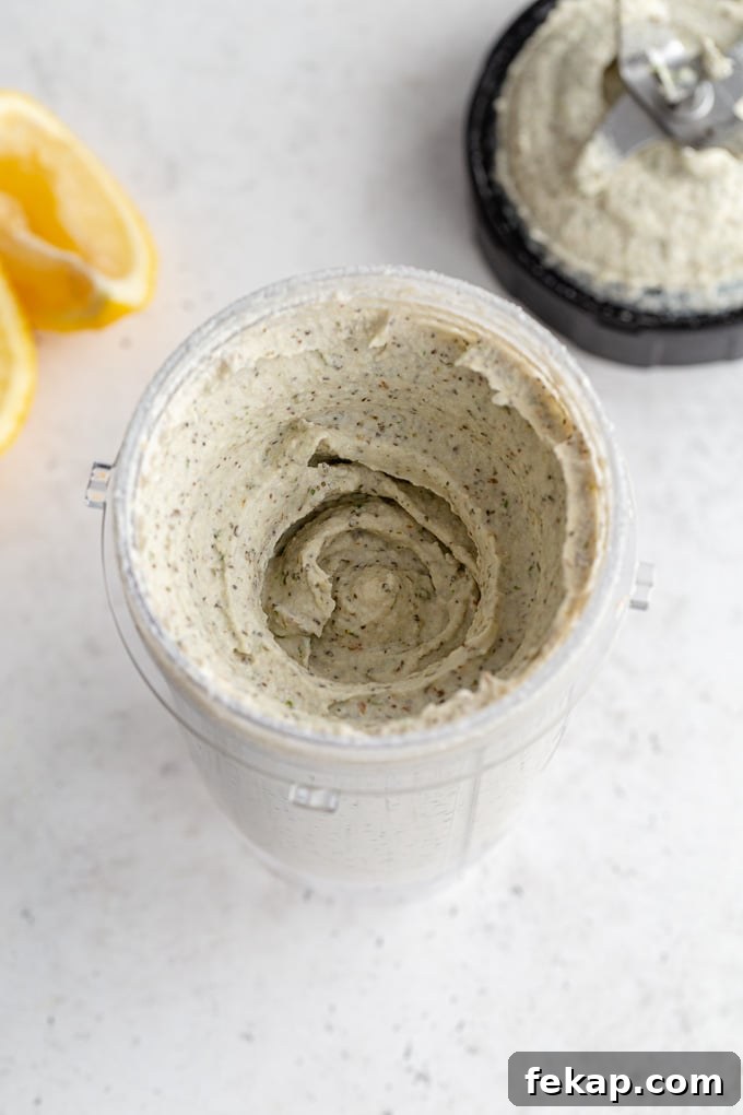 Creamy Vegan Herb Dip Recipe 6 Overhead view of the herb dip blended together in a blender cup.