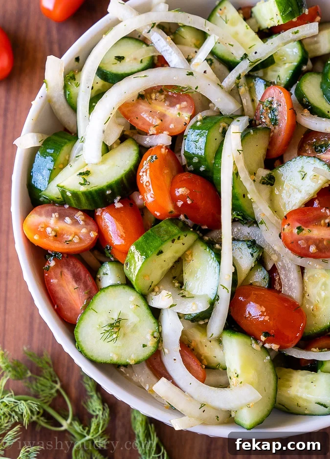 Cucumber Tomato Salad Recipe with Feta and Fresh Herbs 2 White bowl filled with cool cucumbers, tomatoes and sliced onions
