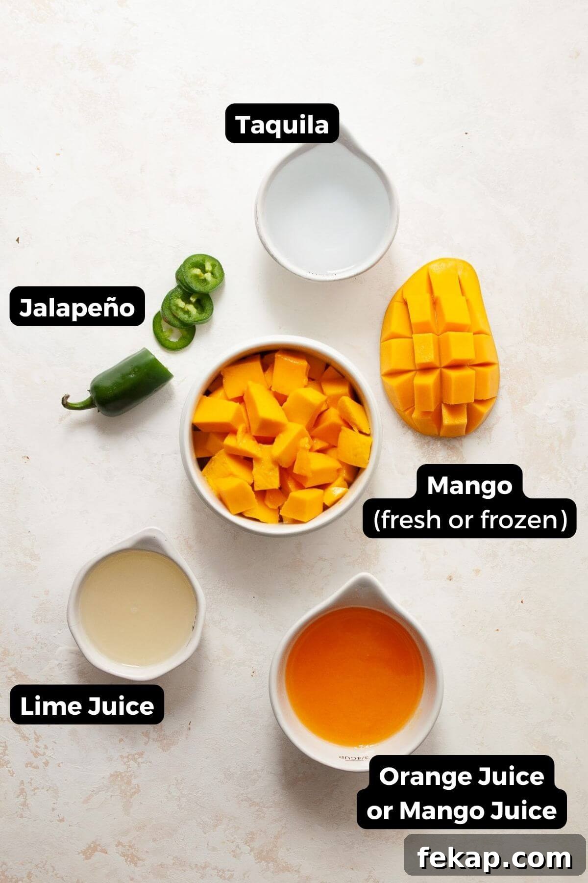 How to Make a Spicy Mango Margarita 3 All five ingredients in small bowls with labels, including: taquila, lime juice, mango juice, mango, and jalapeño.