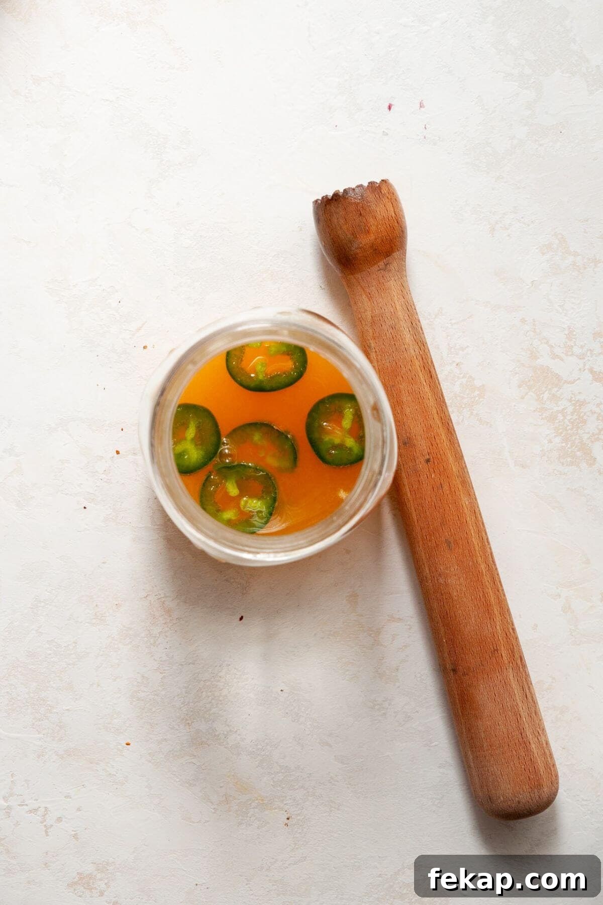 How to Make a Spicy Mango Margarita 5 Muddling jalapeños to make spicy mango juice and tequila.
