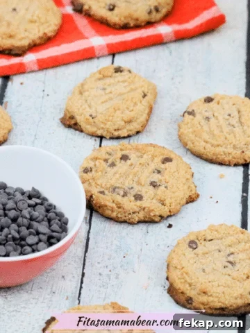 Pinterest image with text: healthy paleo chocolate chip cookies made with made with almond flour laid out with a bowl of chocolate chips