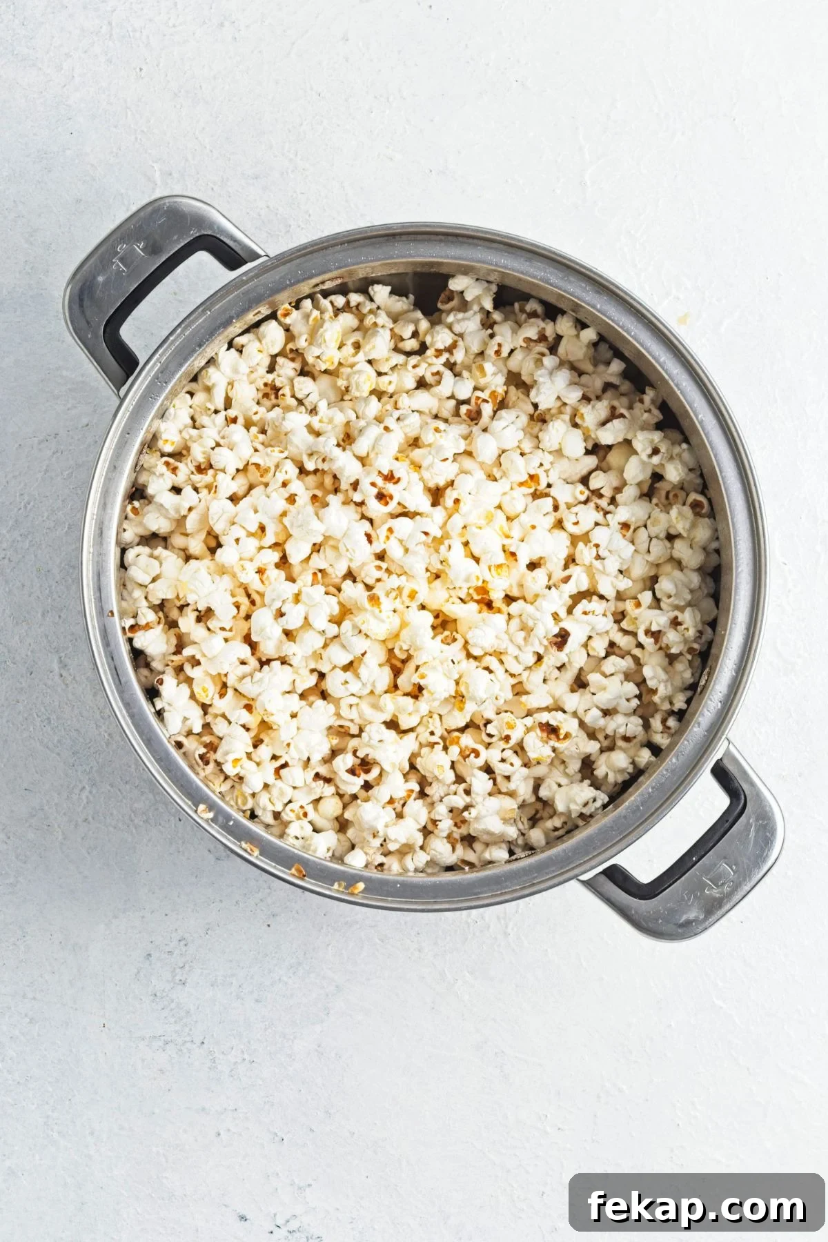 Popped popcorn in a stovetop pot.