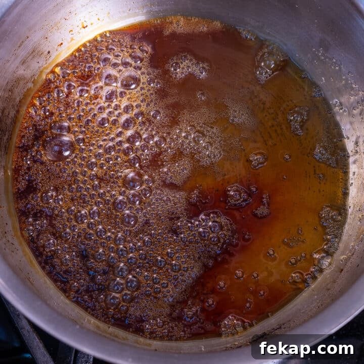 Homemade Salted Caramel Syrup Recipe for Coffee and Desserts 5 amber-colored boiling sugar in a saucepan