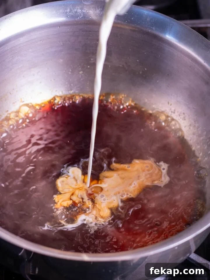 Homemade Salted Caramel Syrup Recipe for Coffee and Desserts 6 pouring heavy cream into the burnt sugar mixture