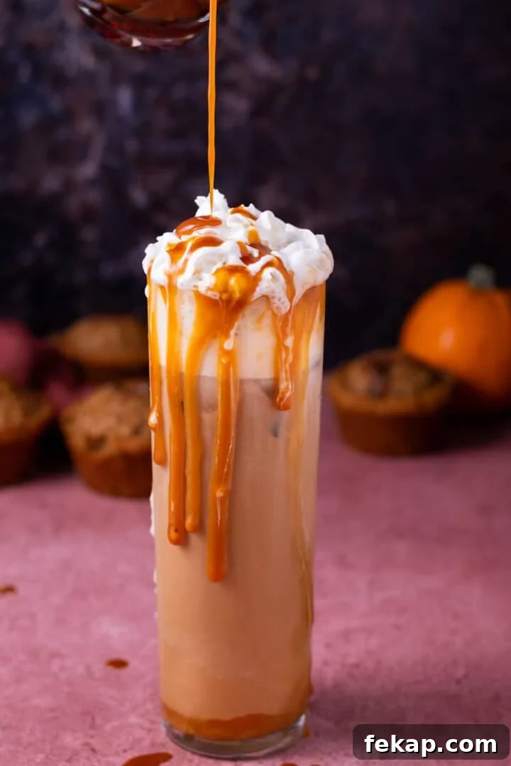 Homemade Salted Caramel Syrup Recipe for Coffee and Desserts 9 pouring caramel syrup on an iced latte topped with whipped cream