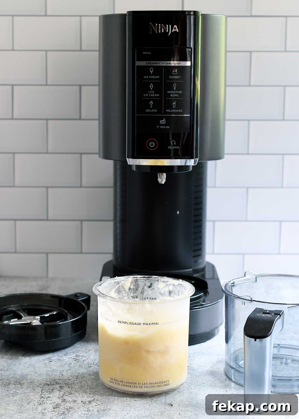 Ninja Creami with a pint of pineapple sorbet ready to spin.
