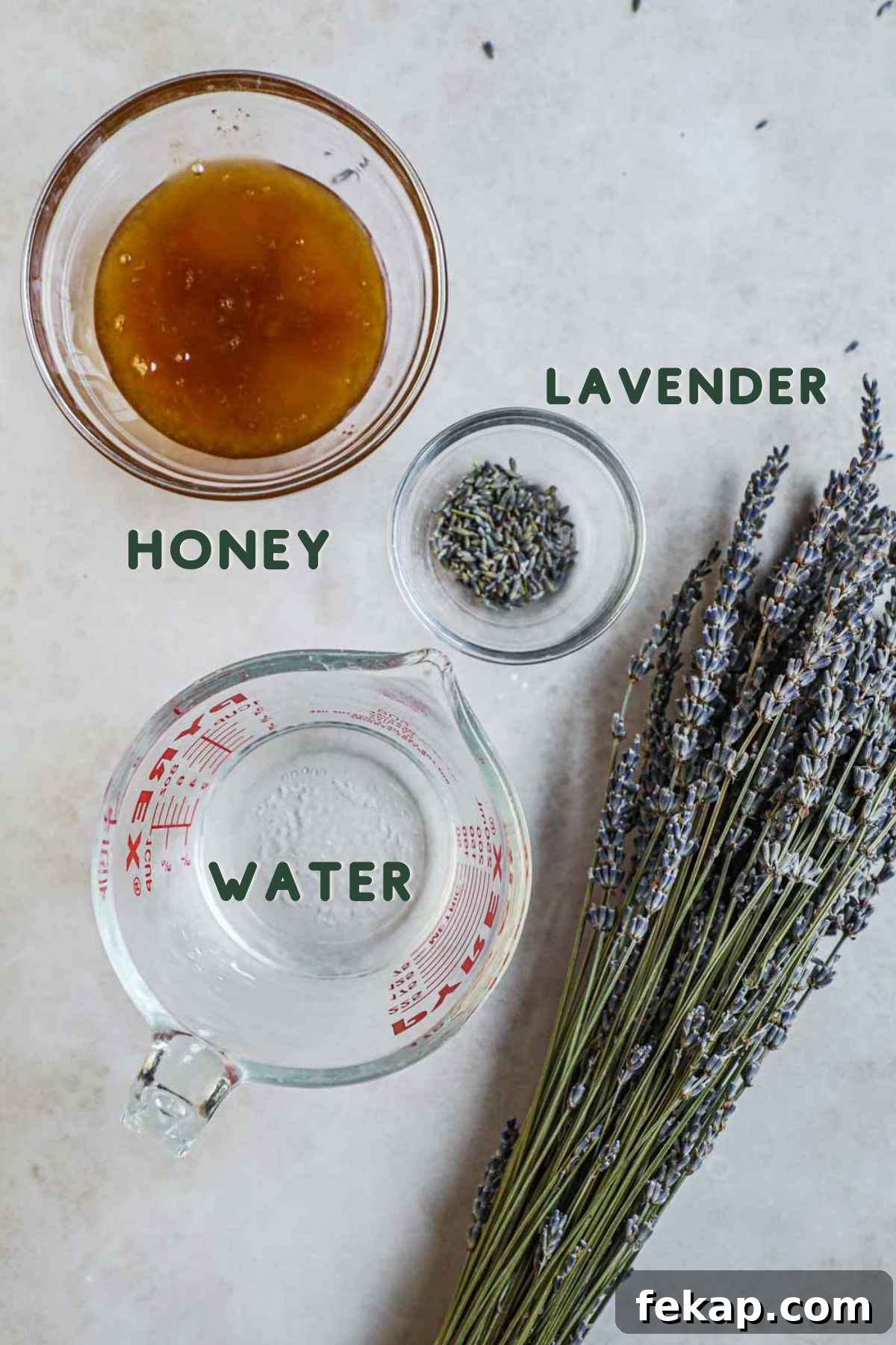 Honey Lavender Simple Syrup Recipe for Cocktails and Desserts 3 Ingredients to make honey lavender simple syrup, including honey, dried lavender petals, and water.