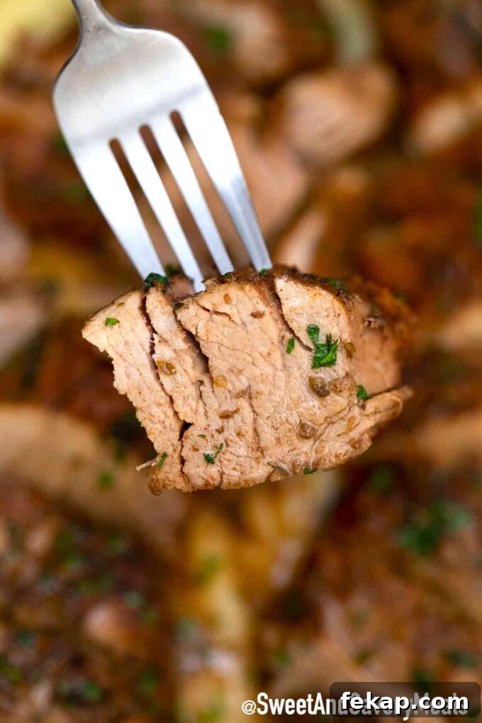 A fork with a slice of juicy pork tenderloin cooked in a slow cooker.