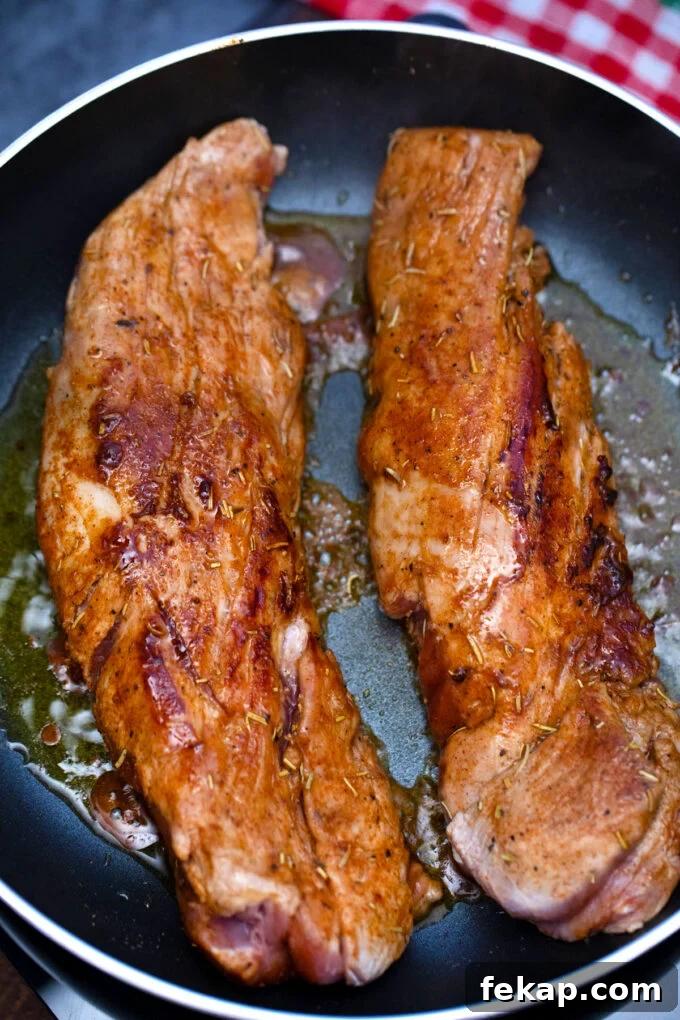 Searing pork tenderloins.