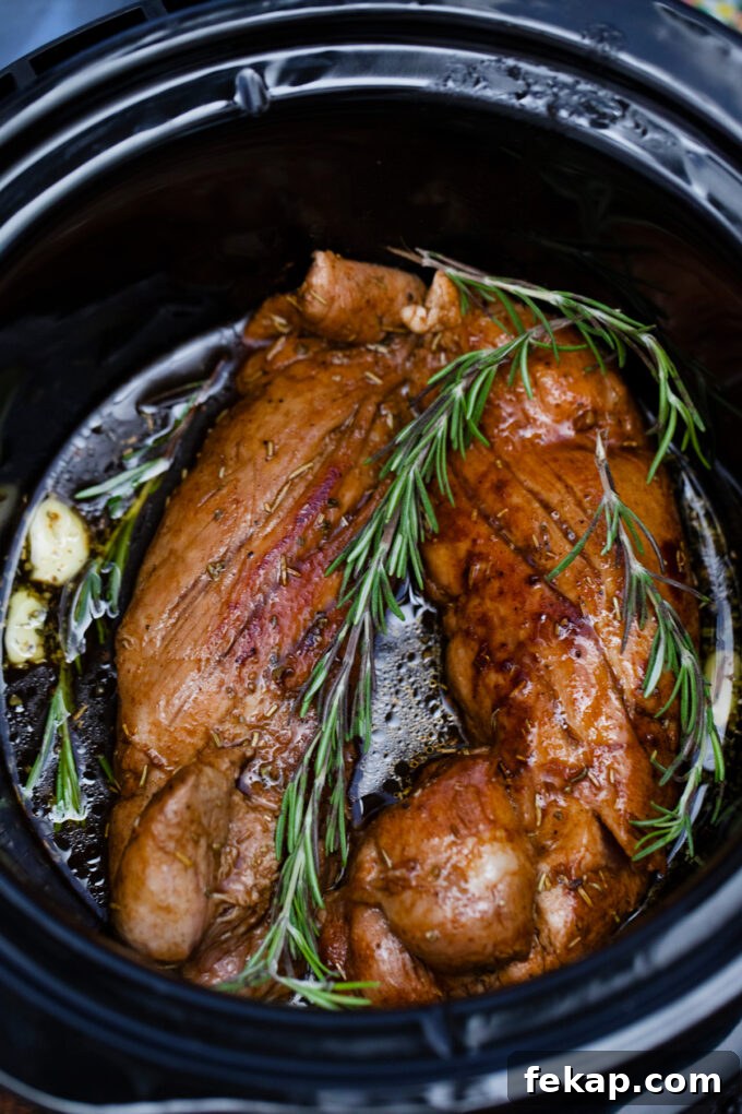 Overhead shot of juicy balsamic pork tenderloin with rosemary and garlic.