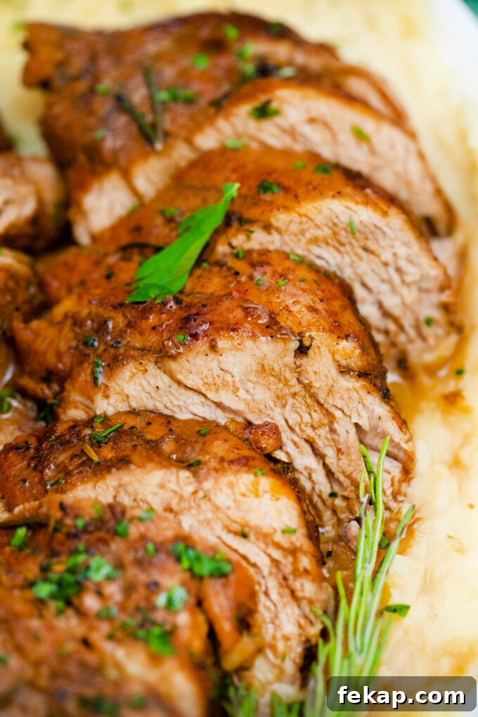 Sliced juicy balsamic pork tenderloin over mashed potatoes.