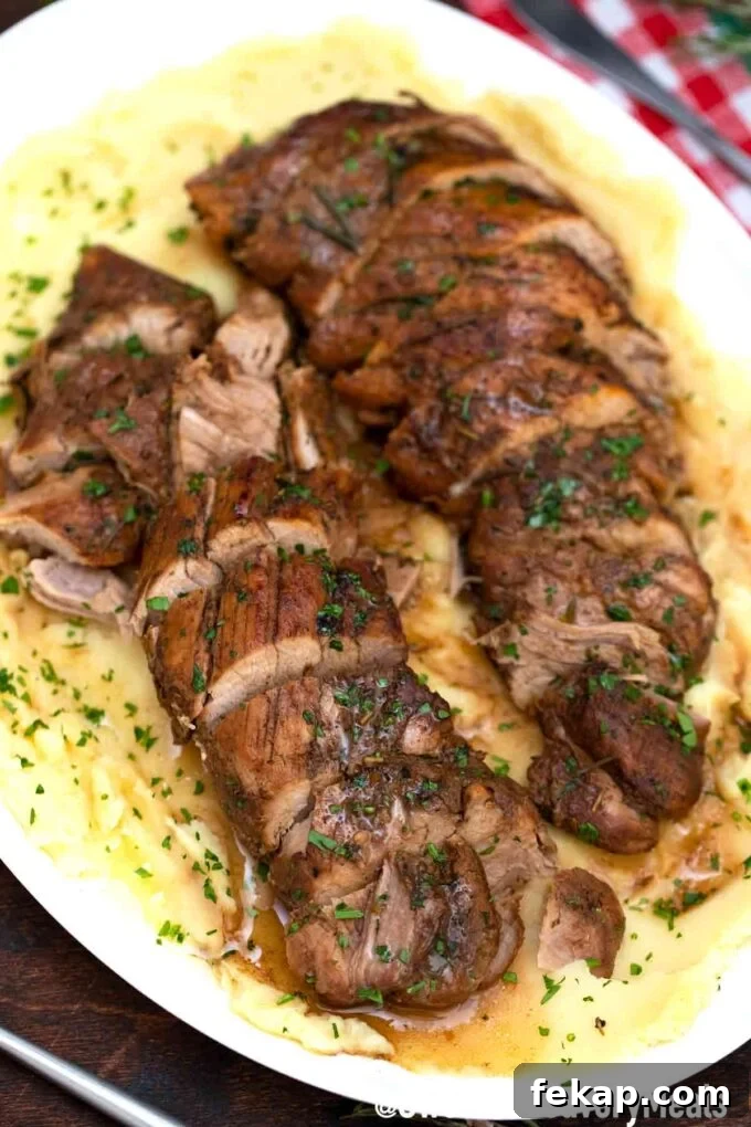 Very tender sliced balsamic pork tenderloin over mashed potatoes.