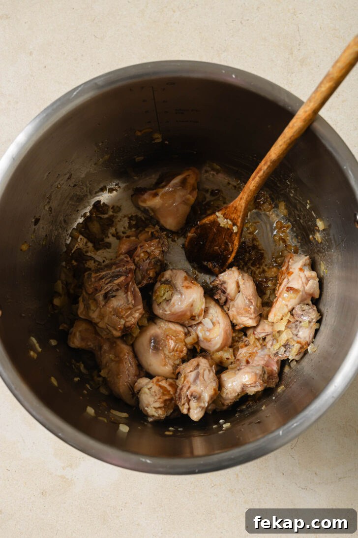 Cooking chicken in sautéed onions, ginger and garlic in an Instant Pot.