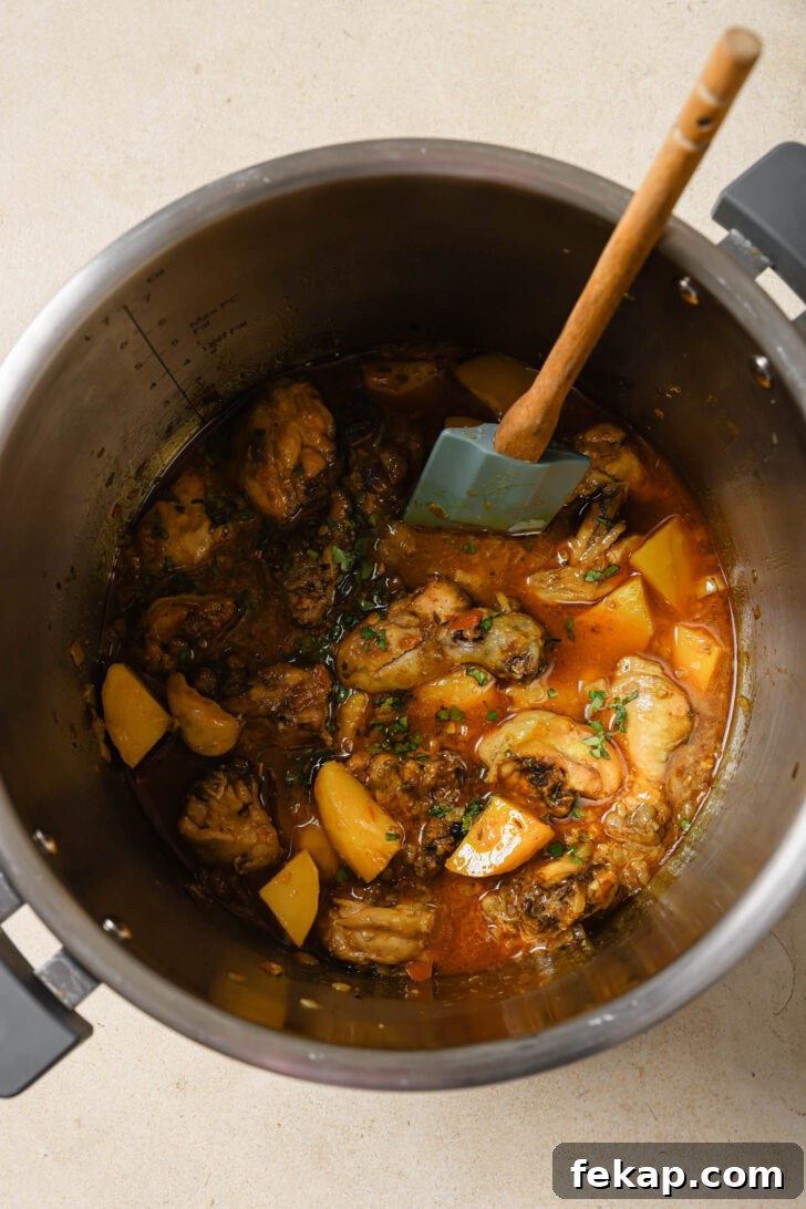 Pakistani Chicken Curry with Potatoes in an Instant Pot garnished with cilantro and garam masala.