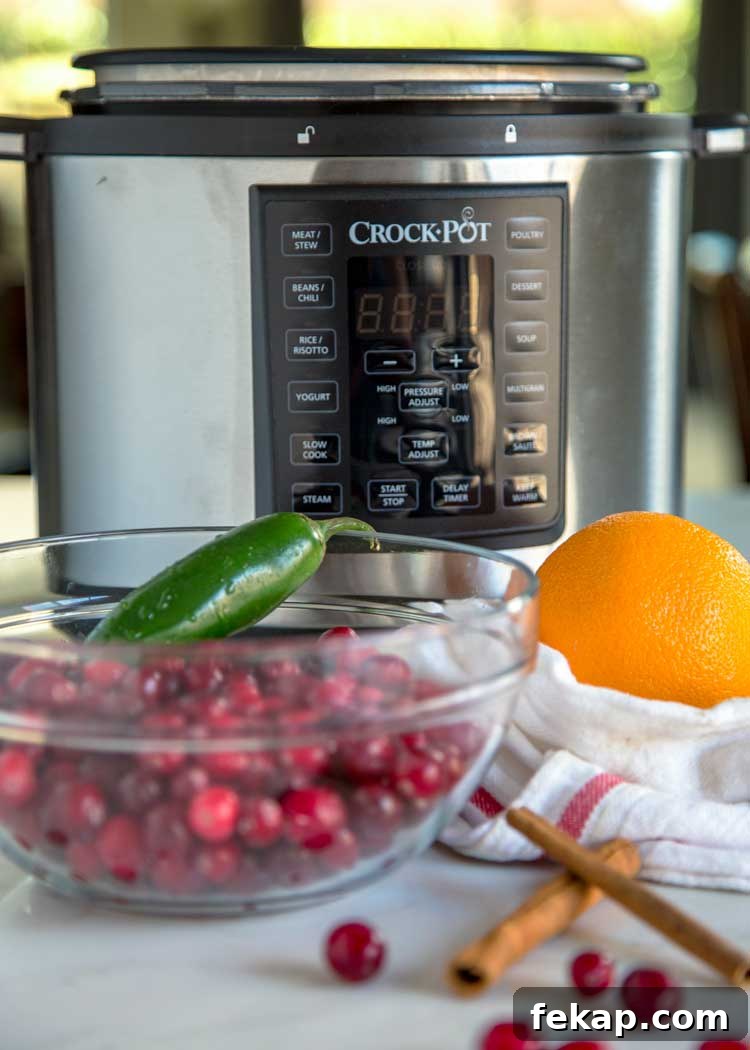 Cranberry butter made in a Crock Pot Express using cranberries, orange zest, cinnamon, brown sugar & chile for a perfect balance of sweet, tangy and spicy. Sweet and Spicy Cranberry Butter