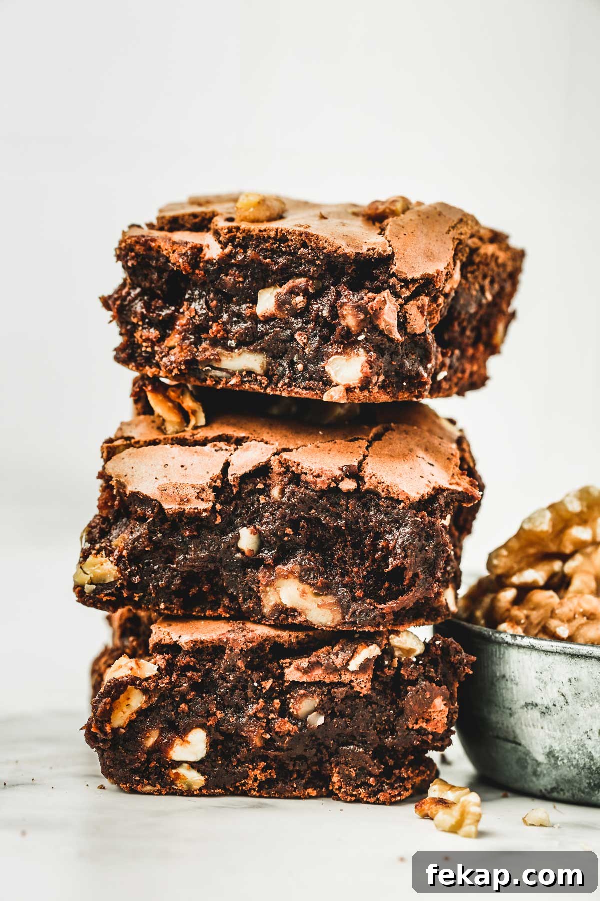 Fudgy Walnut Brownies Recipe 2 brownies with walnuts cut into pieces