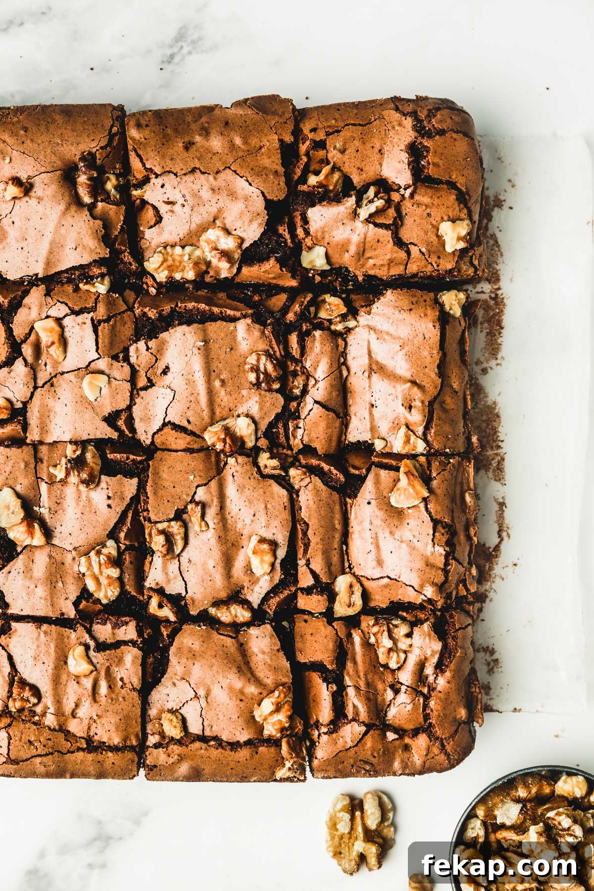 Fudgy Walnut Brownies Recipe 9 brownies with walnuts on a table