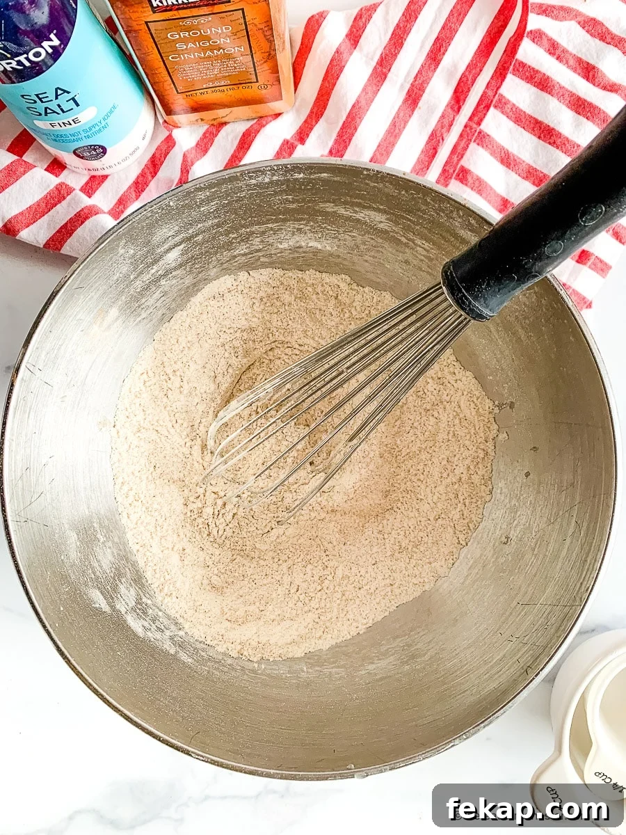 Coffee Cake Muffins with Cinnamon Streusel 5 Mixing cinnamon muffin recipe ingredients in a mixing bowl.