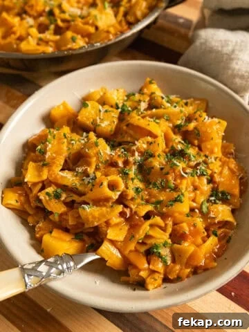 Pasta and Potatoes on a plate topped with parsley and parmesan.