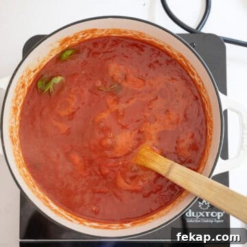 Crispy Italian Pan-Fried Meatballs Recipe 9 Tomato sauce simmering.